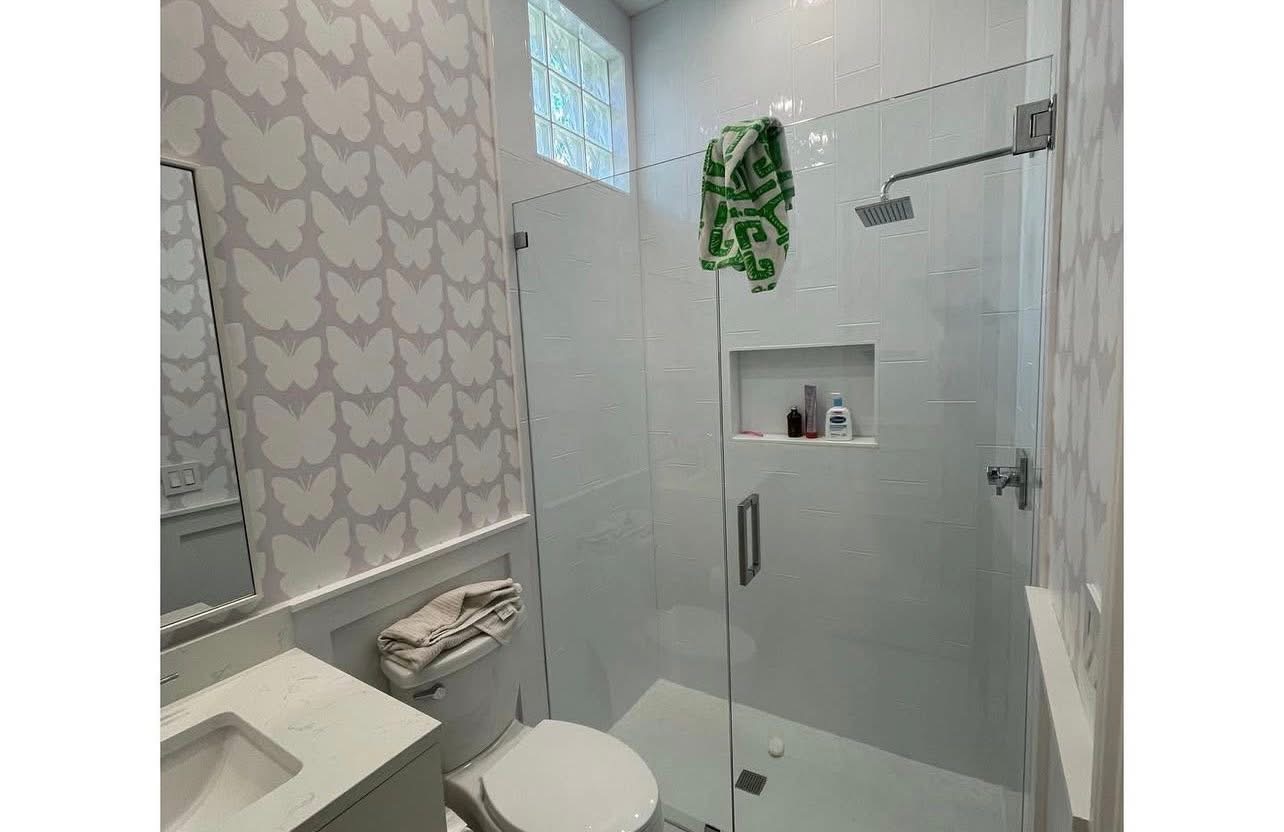 Frameless glass shower with custom tile and niche
