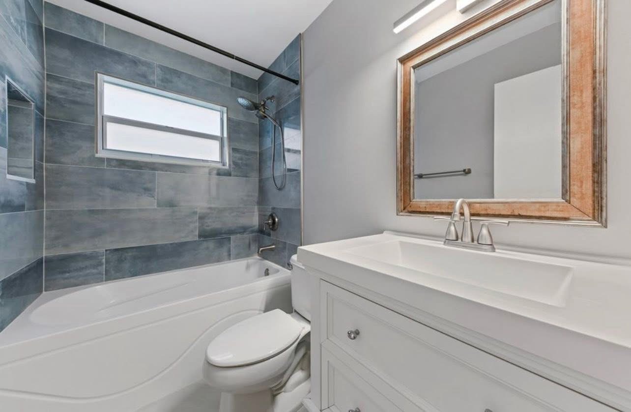 Bathroom remodel with slate blue tub surround