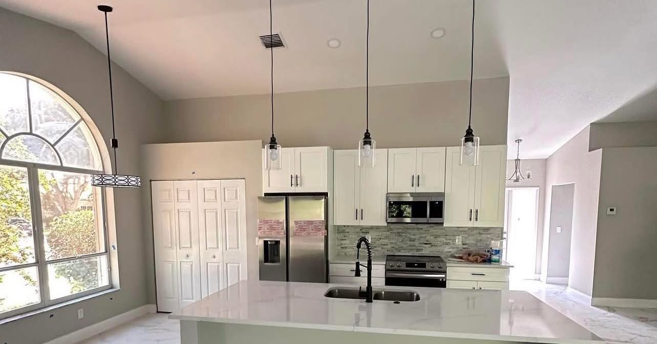 Bright kitchen remodel with vaulted ceiling and arched window