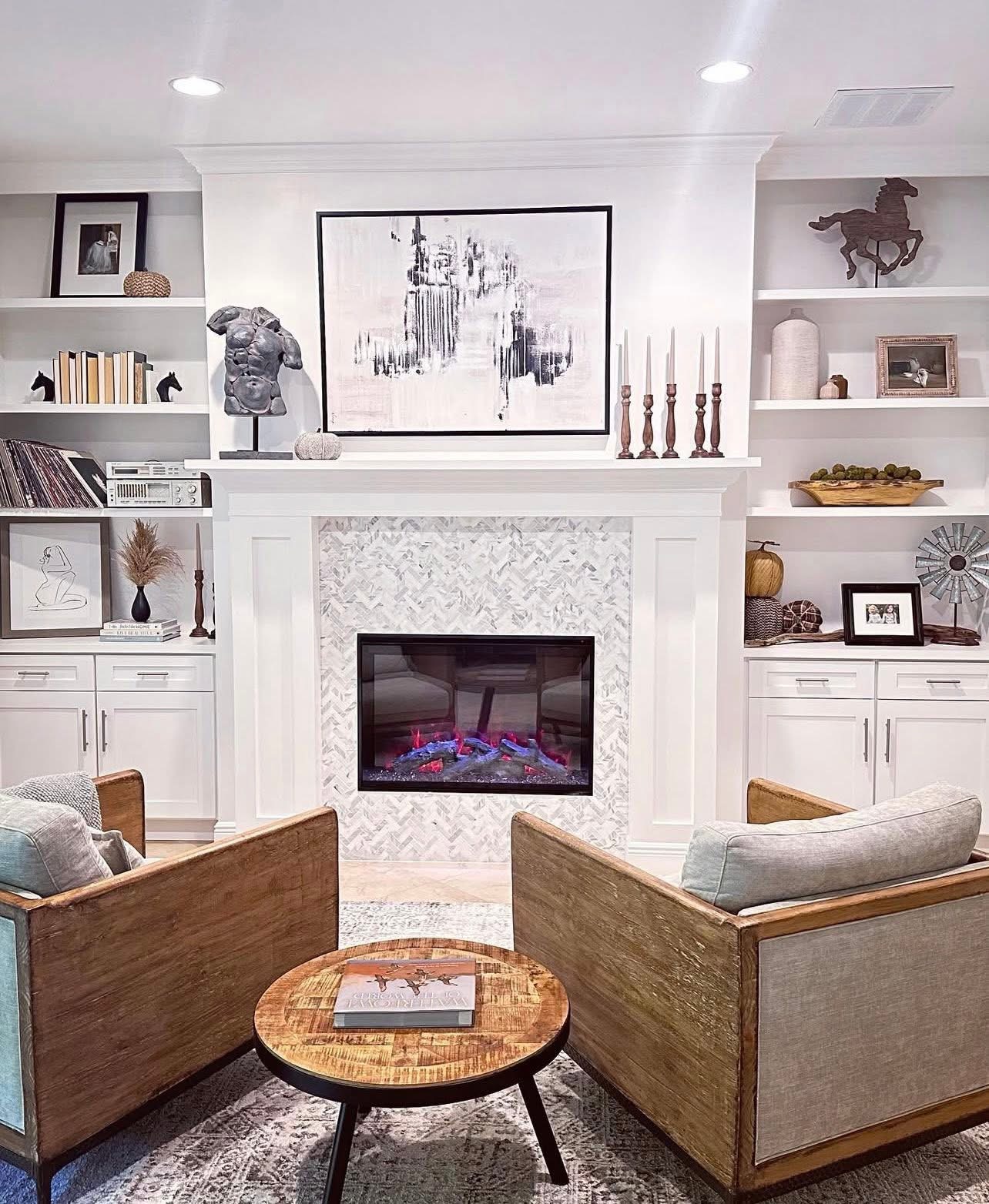 Built-in shelving and herringbone tile fireplace surround